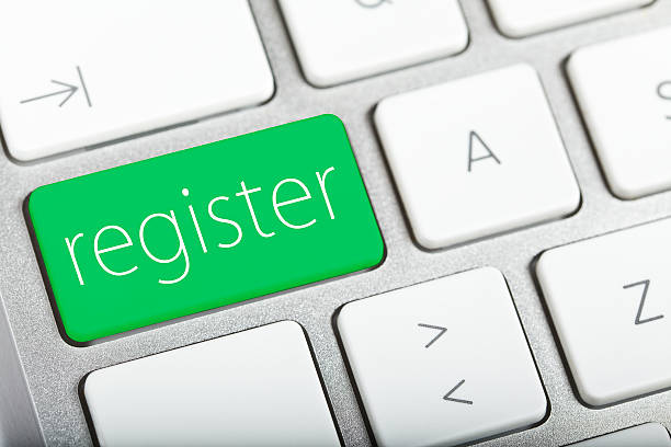 A green register button key on a laptop keyboard