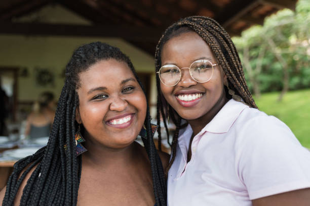 Two sisters, friendship, young women, looking, hair with braids, facial expression, human face